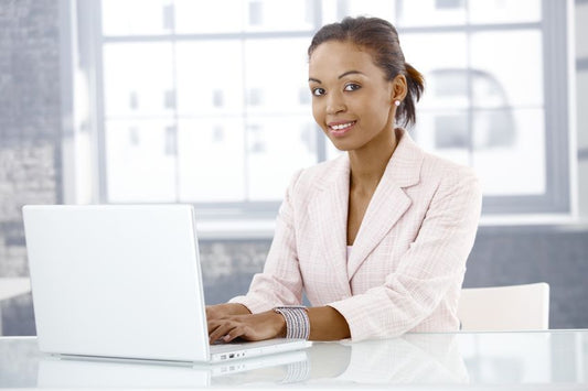 Young woman of color at laptop