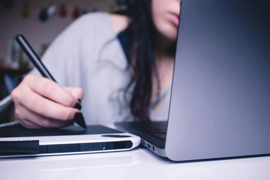 woman with laptop, tablet and stylus