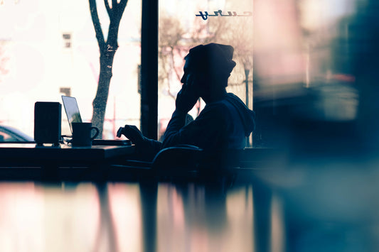 Sillouette of person at computer